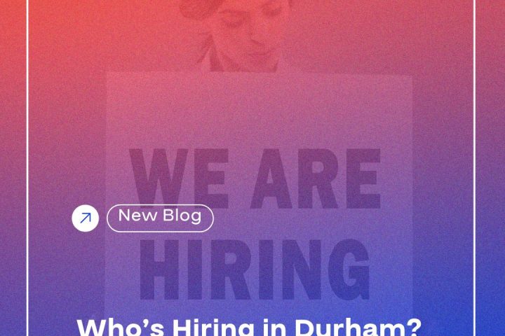 A woman gazes at a sign that reads "WE ARE HIRING Who's Hiring in Durham? A Deep Dive into Job Demand in Q2 2025 durhamworkforceauthority.ca/blog." The sign features a mix of text and graphic design elements.